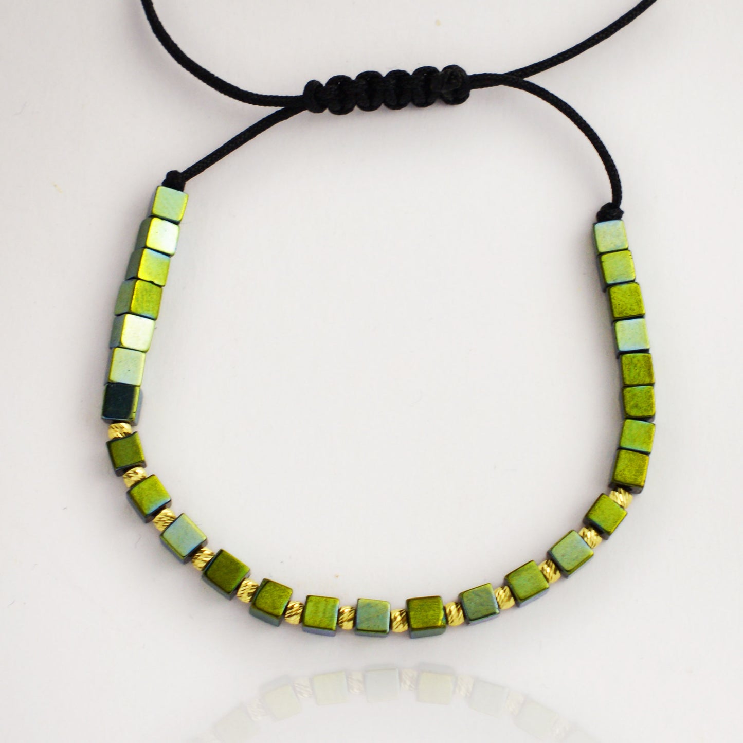 Gold on black thread with hematite