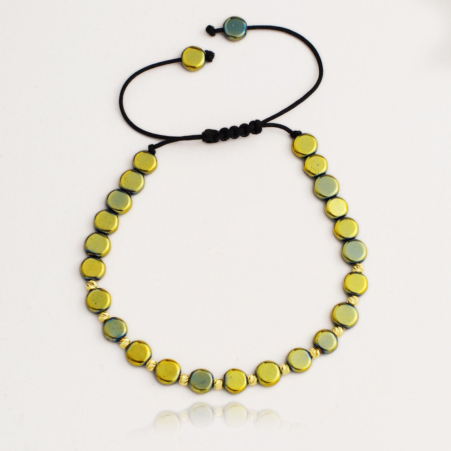 Gold on black thread with hematite