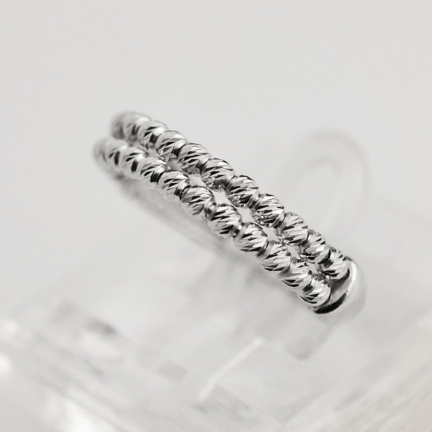 White gold ring with faceted beads