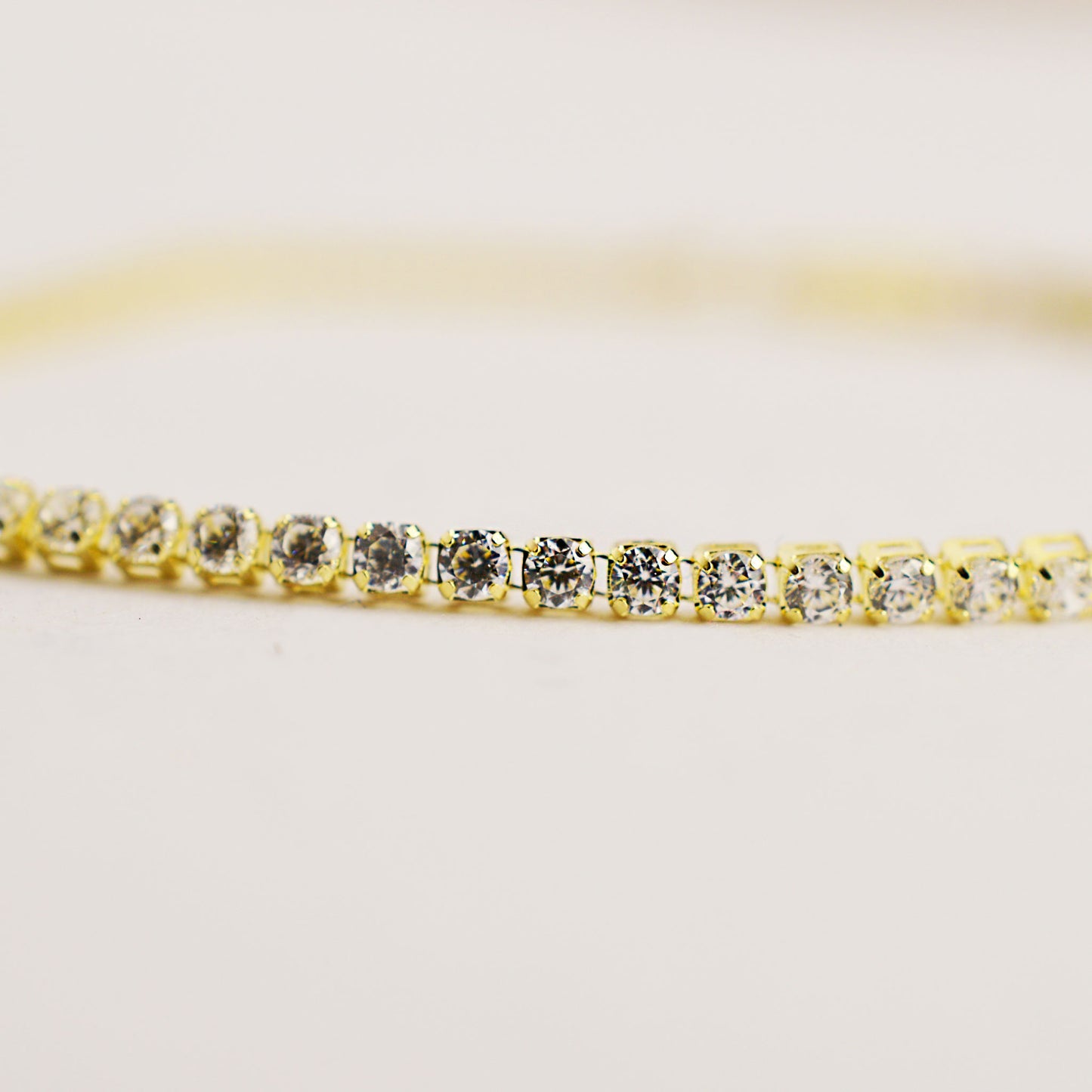 Gold tennis bracelet with white stones