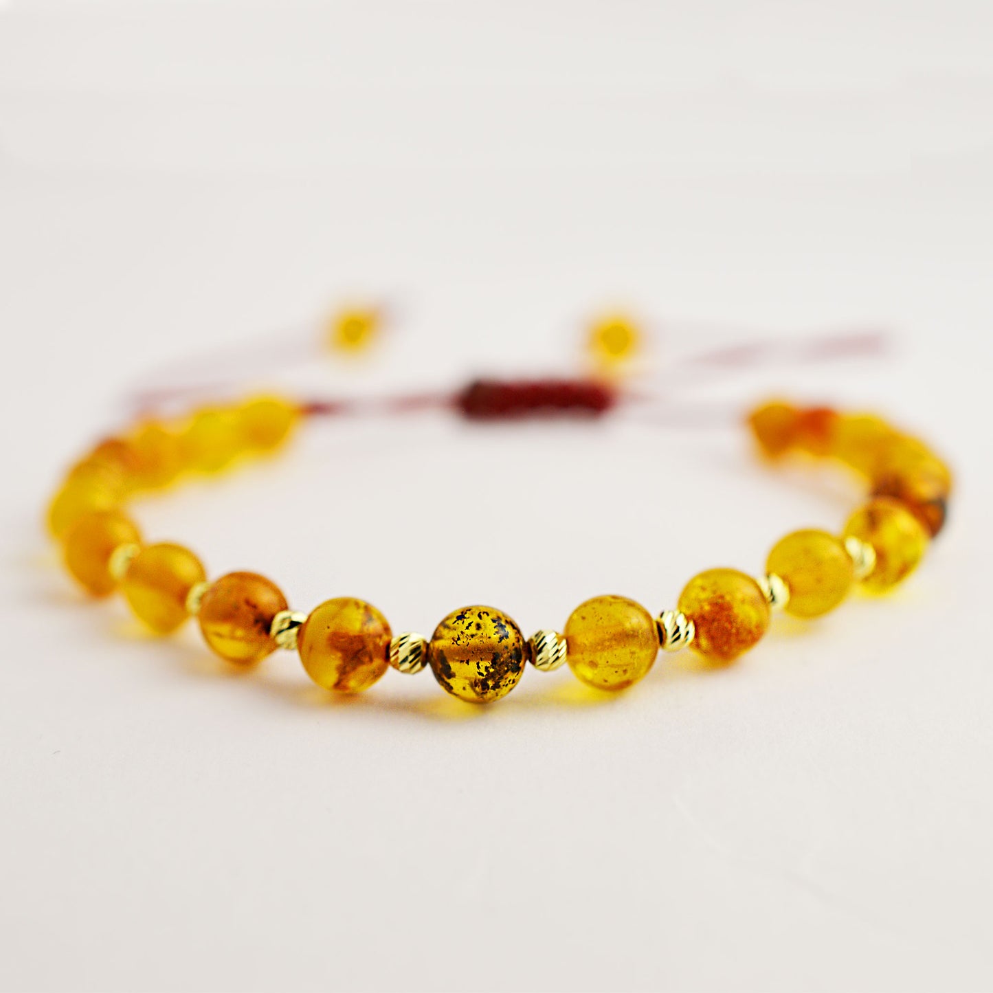 Gold bracelet on thread with amber