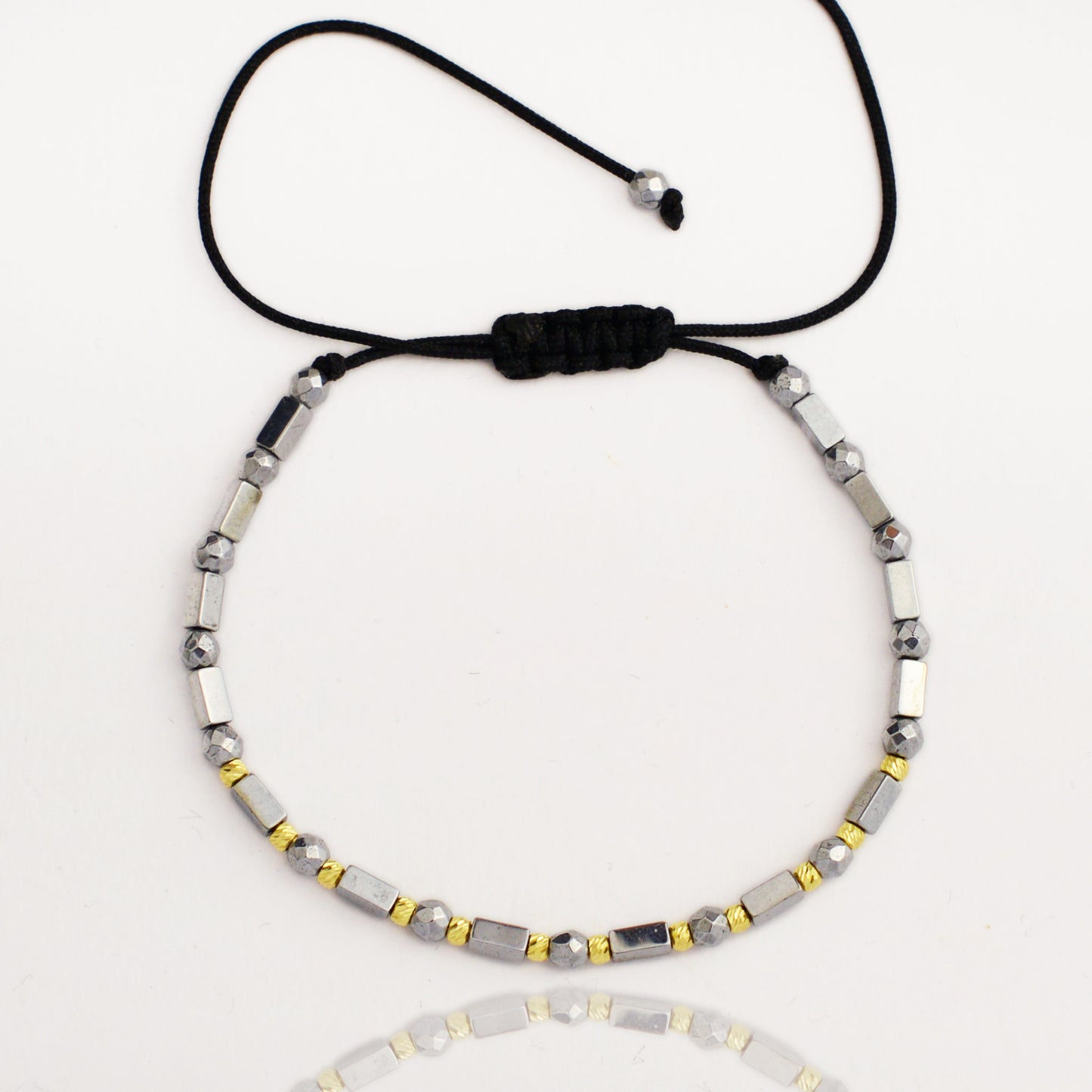 Gold on black thread with hematite