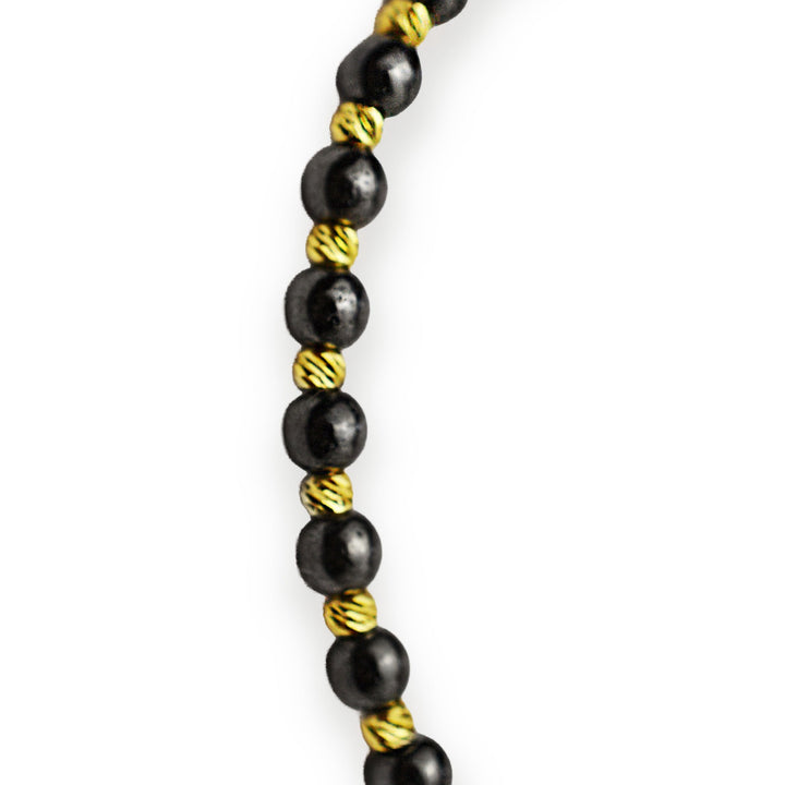 Gold on black thread with hematite