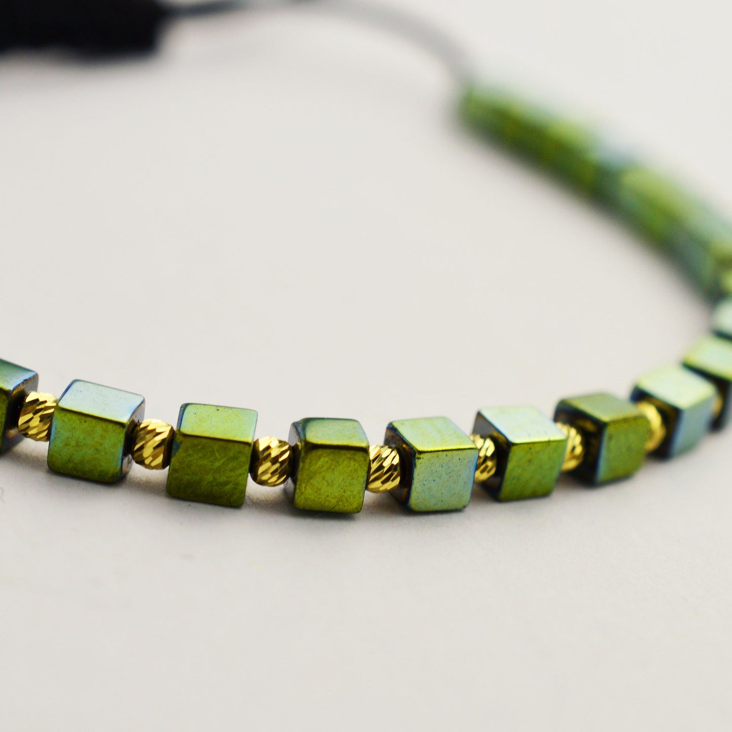 Gold on black thread with hematite