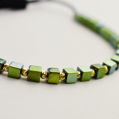 Gold on black thread with hematite