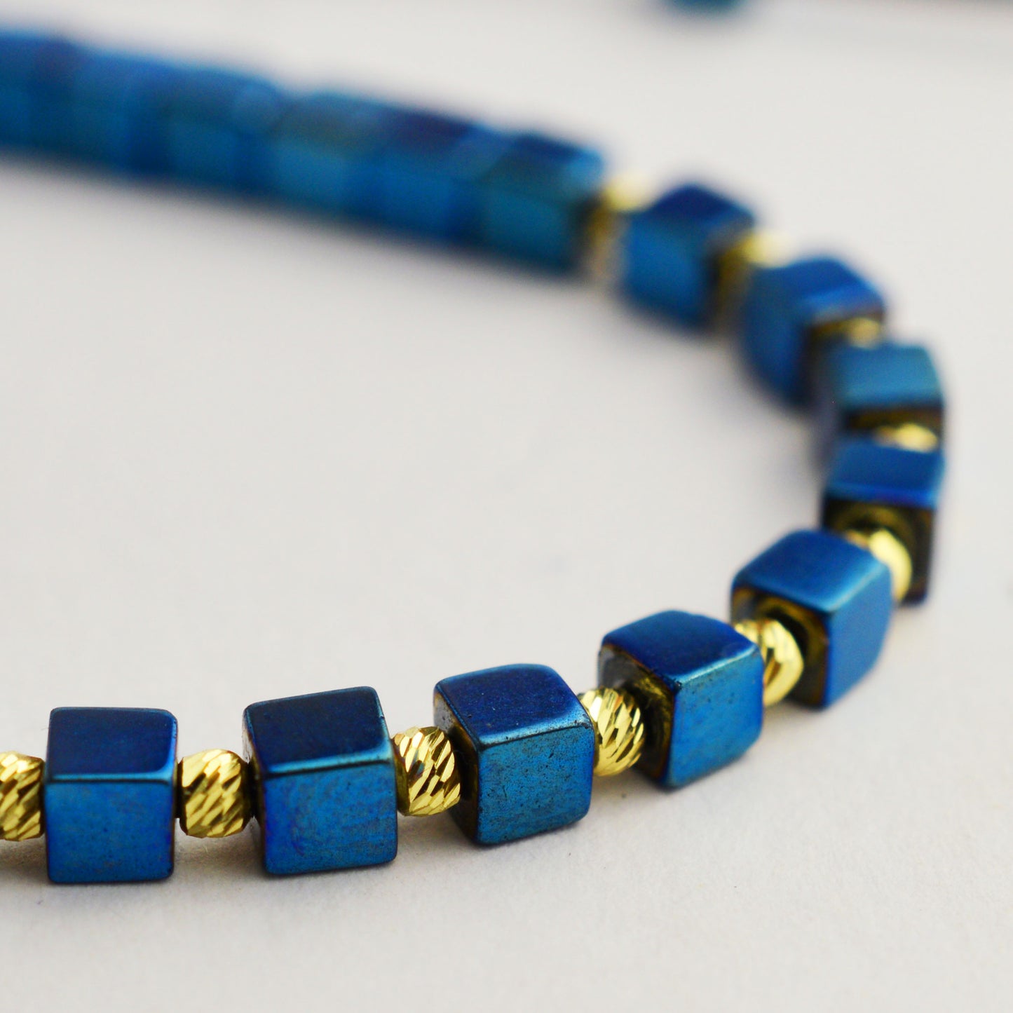 Gold on black thread with hematite