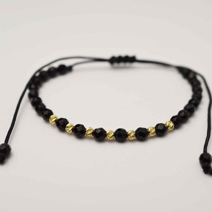 Gold on black thread with onyx 