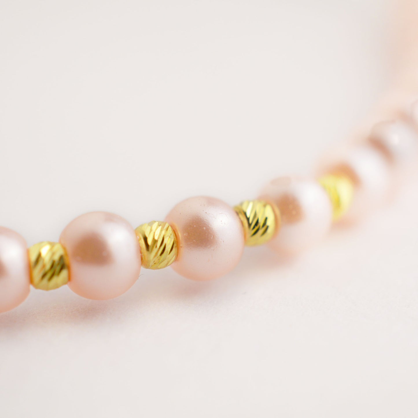 Gold on a thread with a pearl