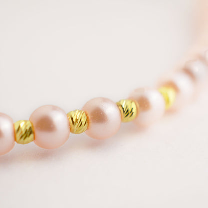 Gold on a thread with a pearl