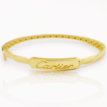Златна твърда гривна Cartier