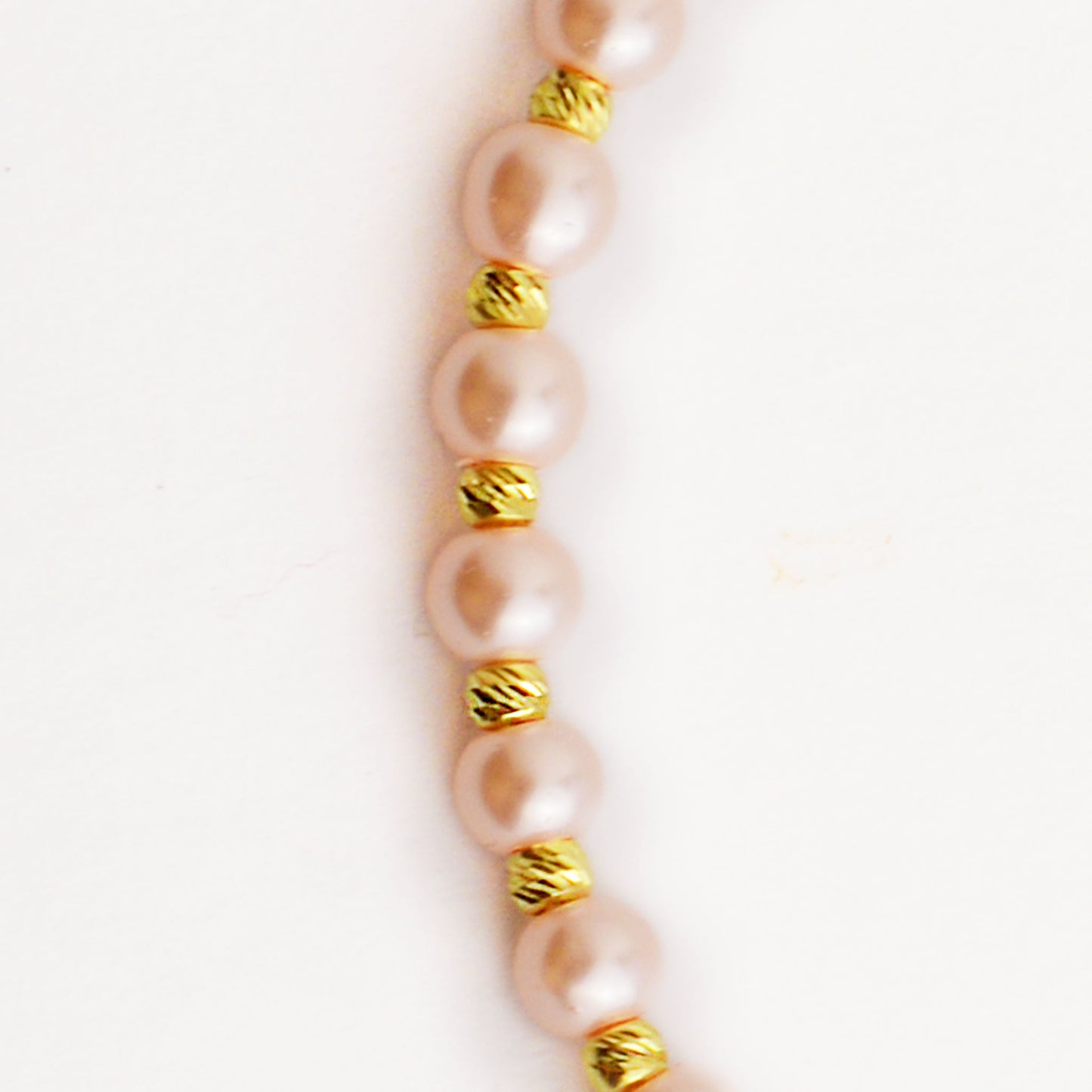 Gold on a thread with a pearl