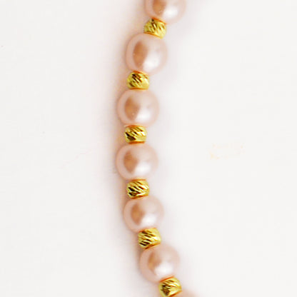 Gold on a thread with a pearl