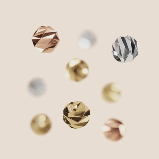 White, rose and yellow gold balls floating in the air